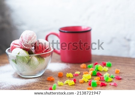 Multicolored cookies in the form of Nuts with filled cream and candied fruit and cup of coffee on a wooden table. Homemade cookies. Copy space. Tasty sweets