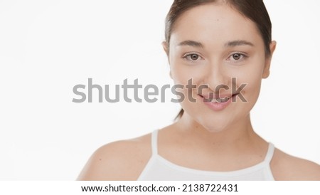 Close-up beauty portrait of pretty brunette Caucasian woman white top on white background | Droopy eyes removal concept Royalty-Free Stock Photo #2138722431