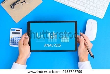 Businessman examines sales data and an economic growth graph graphic on a tablet and laptop. This is a business strategy. Digital marketing is a term that refers to the use of Technology concept 