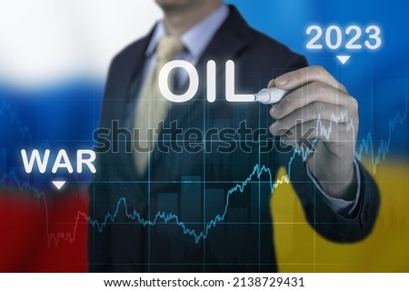 Rising energy costs in 2023 as result of Russia's invasion of Ukraine. Businessman pointing gas price growth in 2023 chart. sharp rise in oil prices as result of hostilities in Ukraine Royalty-Free Stock Photo #2138729431