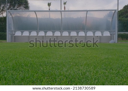 a bench on the green field