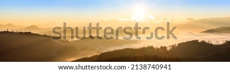 simple shapes silhouette of mountains at sunset, warm colours in golden hour, panorama Royalty-Free Stock Photo #2138740941