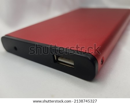 not focus, noise and grainy of photo red black hard drive side view corner with a focus on the usb plug