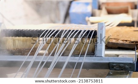 Recycled molten plastic comes out of the extruder machine Concept of recycling, plastic, industry, factories. Continuous extrusion with cooling in water to be processed into a pellet. Royalty-Free Stock Photo #2138753811
