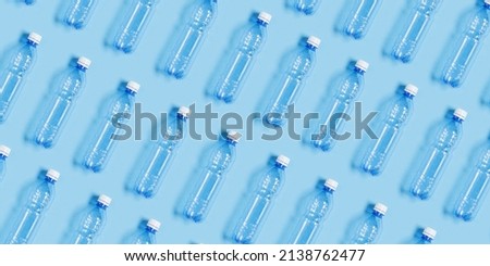Pattern with blue plastic bottles on blue paper background, top view empty plastic bottle for water half litre, minimal wide banner. Pollution, plastic garbage, environmental protection concept Royalty-Free Stock Photo #2138762477