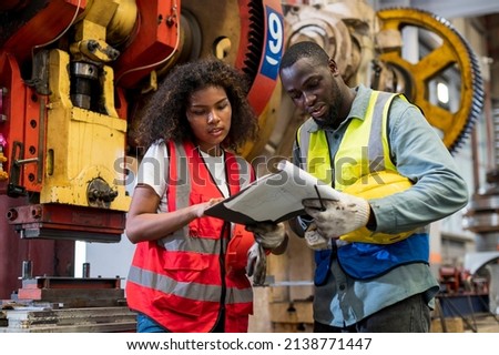 African workers working team service and discussing plan of maintenance machine in heavy industrial factory Royalty-Free Stock Photo #2138771447