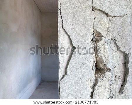 cracked concrete pillar of house that was being built was caused by mistake of plasterer, cement separate construction site. Royalty-Free Stock Photo #2138771985