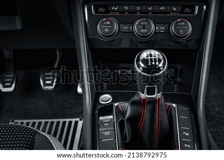 Interior of car. Lever of manual transmission in cabin of car is close-up. Dark style. Background