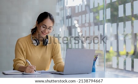 Beautiful Asian woman using a laptop to study online, she is studying online. The concept of online learning due to the COVID-19 outbreak to prevent an outbreak in the classroom.