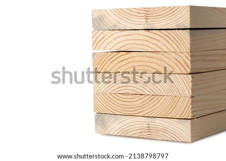 Stacks of pine wood planks on white. Natural rough wooden boards boards, lumber, industrial wood, timber. Royalty-Free Stock Photo #2138798797