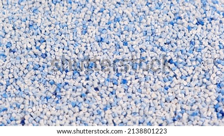 Secondary granule made of polypropylene, Blue Plastic pellets crumbles to the table. Plastic raw materials in granules for industry. Polymer resin. Raw plastic recycling concept Royalty-Free Stock Photo #2138801223