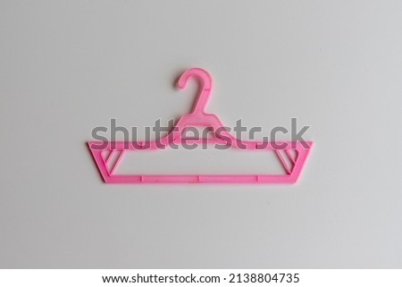 Baby cloth hanger pink color small hanger on white background