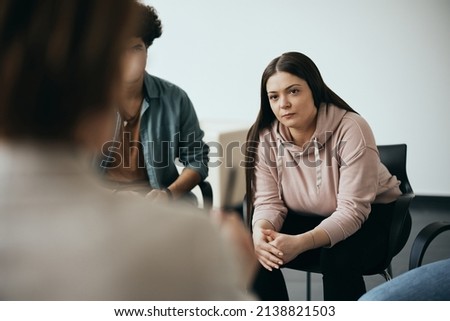 Young woman attending group therapy meeting at mental health center.  Royalty-Free Stock Photo #2138821503