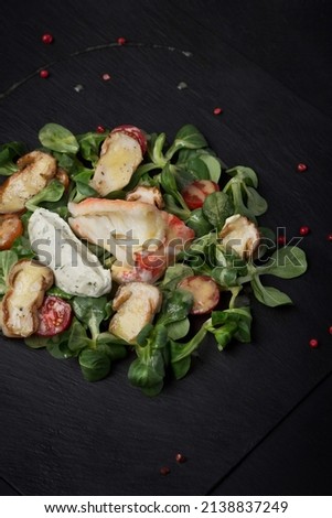Salad with seafood, squid and shrimp. food photography, dark background.