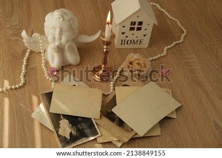 stack of vintage photos, baby photography of 50s, 60s, romantic still life in love style, model house, candles burning, concept of family tree, genealogy, childhood memories Royalty-Free Stock Photo #2138849155