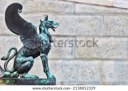 Gryphon statue - Profile picture against wall