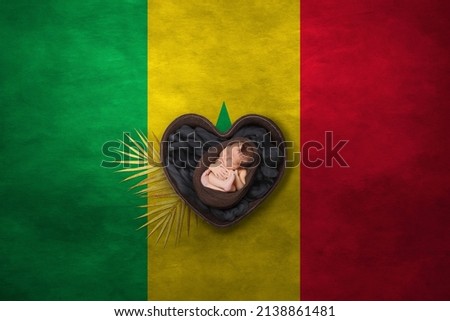 Newborn portrait in heart on background of national flag. Photography peace concept. Senegal