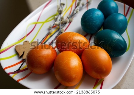 Yellow and blue colored Easter eggs on table top view 