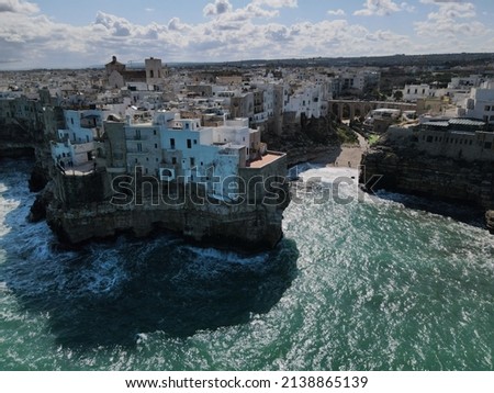 Aerial view of Polignano a Mare, a village built on the edge of the sandstone cliffs above the Adriatic Sea in Apulia, Italy. Drone photography of Lama Monachile bay. Royalty-Free Stock Photo #2138865139