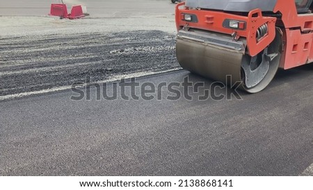 Repair new road asphalting roller. Applying hot resin sidewalk. Industrial equipment with smooth rolling pressure leveling asphalt. Worker building road in city. Smoothing construction highway surface Royalty-Free Stock Photo #2138868141