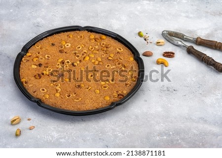 Black Plastic plate with oriental honey sweets  baklava on grey wooden background
Plastic container with oriental honey sweets  fresh strawberry with milk on a wooden table  black background Royalty-Free Stock Photo #2138871181