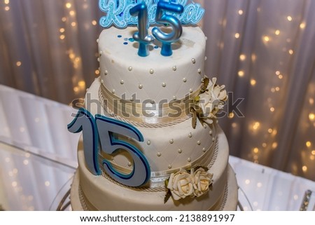 high heels, platform cake with several floors of 15 year old debutante birthday party with candle and ornaments