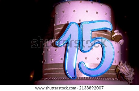 high heels, platform cake with several floors of 15 year old debutante birthday party with candle and ornaments