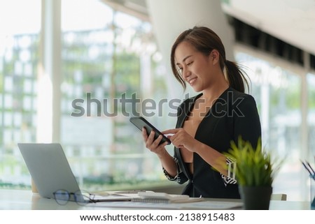 A businesswoman completes KYC using an online banking program in order to open a digital savings account. The definition of cyber security. Royalty-Free Stock Photo #2138915483