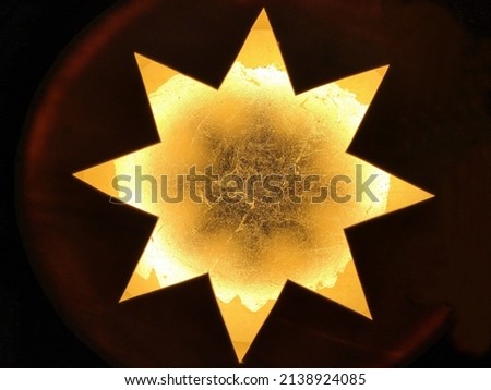 Christmas star with metal texture. Abstract decorative background. Grunge modern natural ornament. Geometric pattern with polygonal structure.Bright close-up macro photo of panel surface.