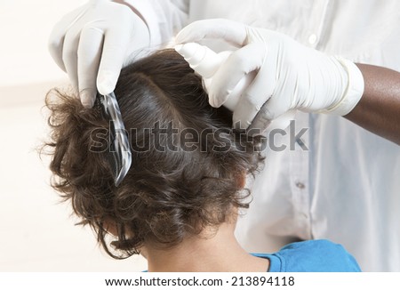Woman inspect child head for lice.