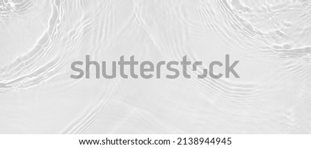 Transparent clear white water surface texture with ripples, splashes and bubbles. Abstract summer banner background Water waves in sunlight with copy space Cosmetic moisturizer micellar toner emulsion Royalty-Free Stock Photo #2138944945