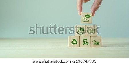 Low carbon,carbon neutral concept. Net zero greenhouse gas emissions target. Climate neutral long term strategy. Hand put wooden cubes with decarbonization icon and green icon. Green banner. LCA. ISO. Royalty-Free Stock Photo #2138947931
