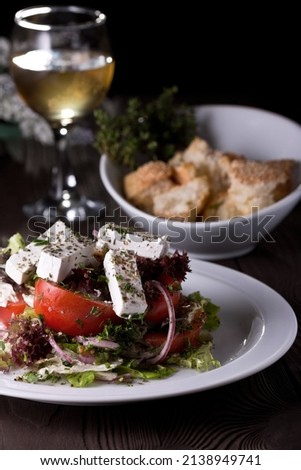Greek salad, tomatoes and cheese. Food photography, dark background