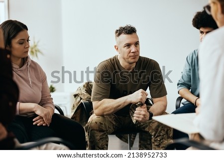 Mid adult veteran attending group therapy session at mental health center. Royalty-Free Stock Photo #2138952733