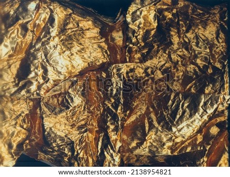 Wrinkled fabric texture. Gold crumpled background