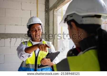 A female engineer is scolding her colleague for doing the wrong job.Working together of people of different nationalities, diversity.Dissent opinions on work, controversy.bad supervisor blame worker. Royalty-Free Stock Photo #2138968521