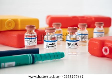 Insulin ampoules and insulin syringe with cold packs against a white background: properly cooling and storing insulin.  Royalty-Free Stock Photo #2138977669
