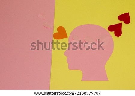red hearts on a yellow background reach the pink paper head and turn pink, come out of the head and squeak orange eventually reaches the pink background and become pink again merge, creative art love