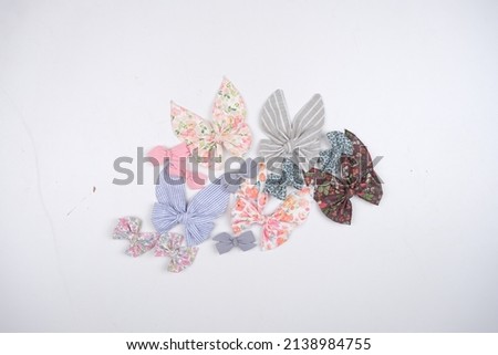 She chooses colorful hair accessories. Bow and ribbon for children. Hairstyle and accessory for kids. Spring selection. Rainbow ribbons for girls. view from above on white