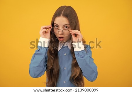 Just curious. Curious girl in eyeglasses. Nerdy-looking kid yellow background. Back to school Royalty-Free Stock Photo #2139000099