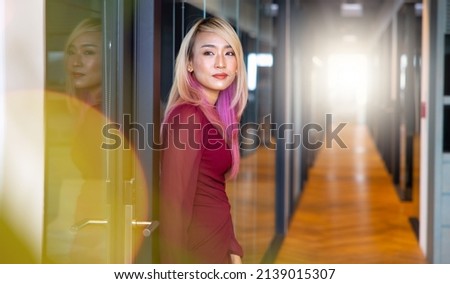 Portrait Attractive beautiful Asian business woman in suit working in home office.
