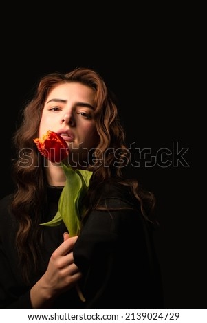 girl with a bouquet of tulips on black background. International Women's Day. Valentine's Day.