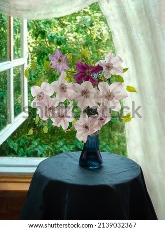 Still life with bouquet of clematis on open window background