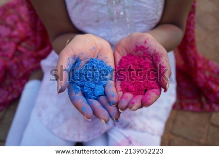 holi celebrations, young woman playing holi festival with dry Colors Royalty-Free Stock Photo #2139052223