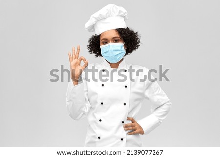 cooking, pandemic and health concept - happy smiling female chef in protective medical mask over grey background