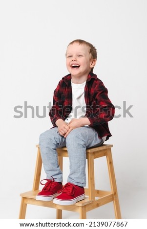 Portrait of a little smiling boy on white plain background - preschool kid
