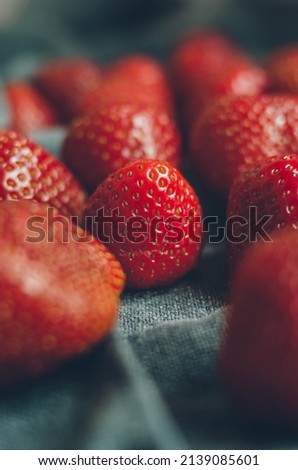 Macro photo of the big sweet ripe strawberry. Fresh red berries on towel close up