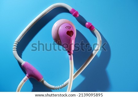 old toy stethoscope on blue background                     
