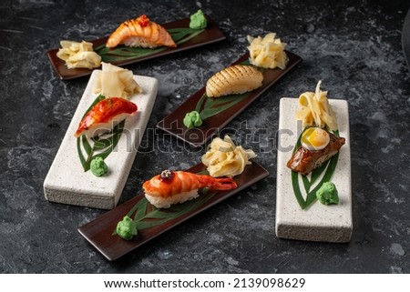 Top view of assorted mixed Japanese sushi set with rolls, nigiri, soy sauce, ginger. Mixed Sushi Set nigiri. Royalty-Free Stock Photo #2139098629