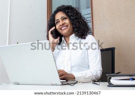 Woman talking with client on Phone in office Royalty-Free Stock Photo #2139130467